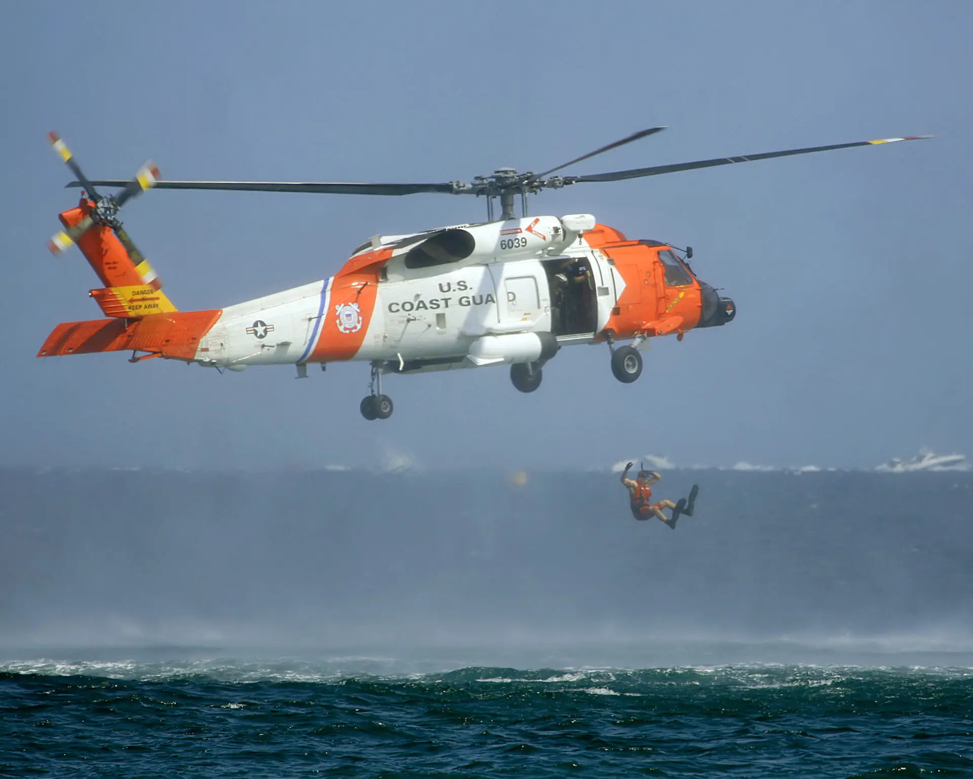 Coast,Guard,Helicopter,Rescuing,Man,From,Ocean.